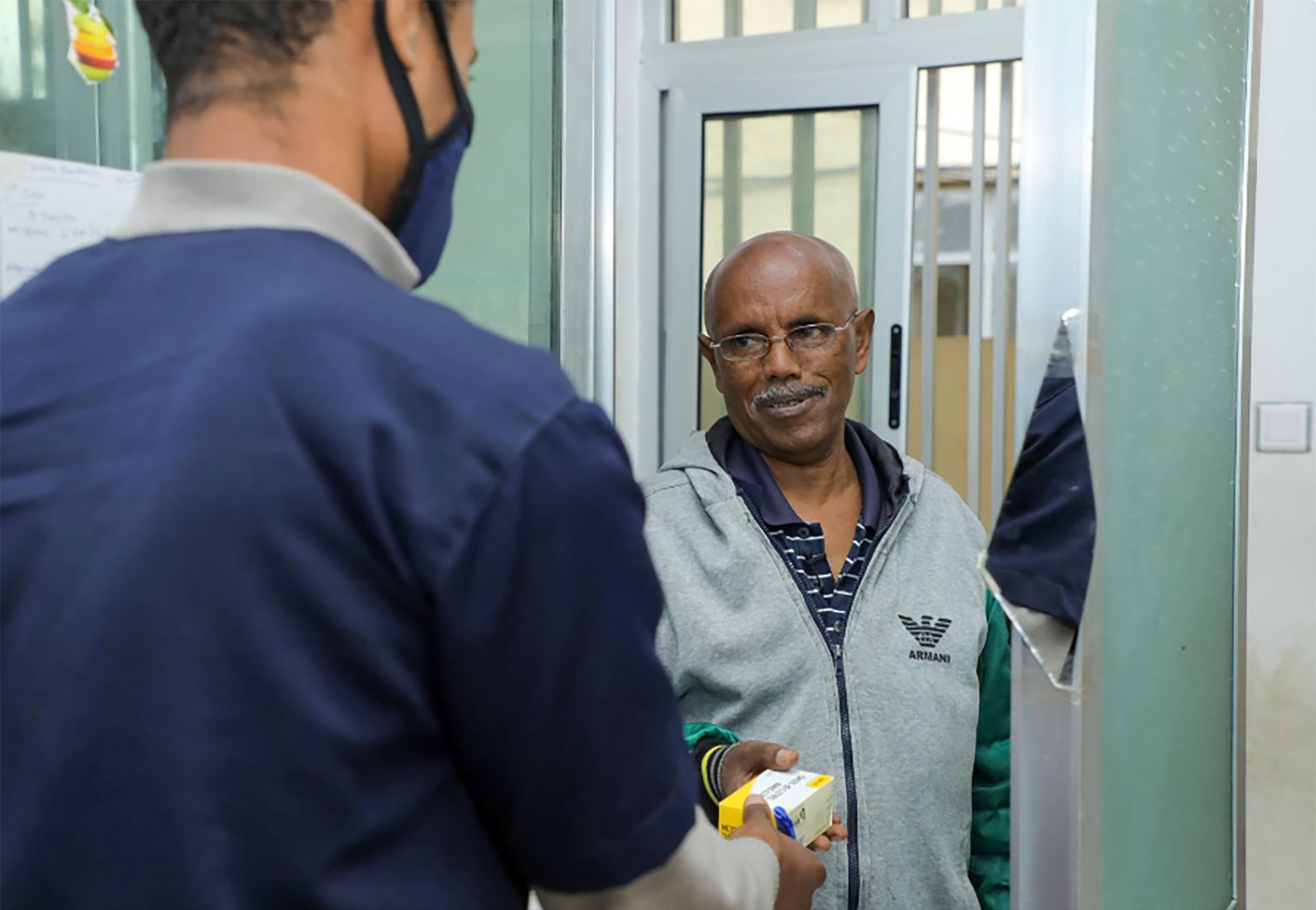 A health worker handing a package to a person