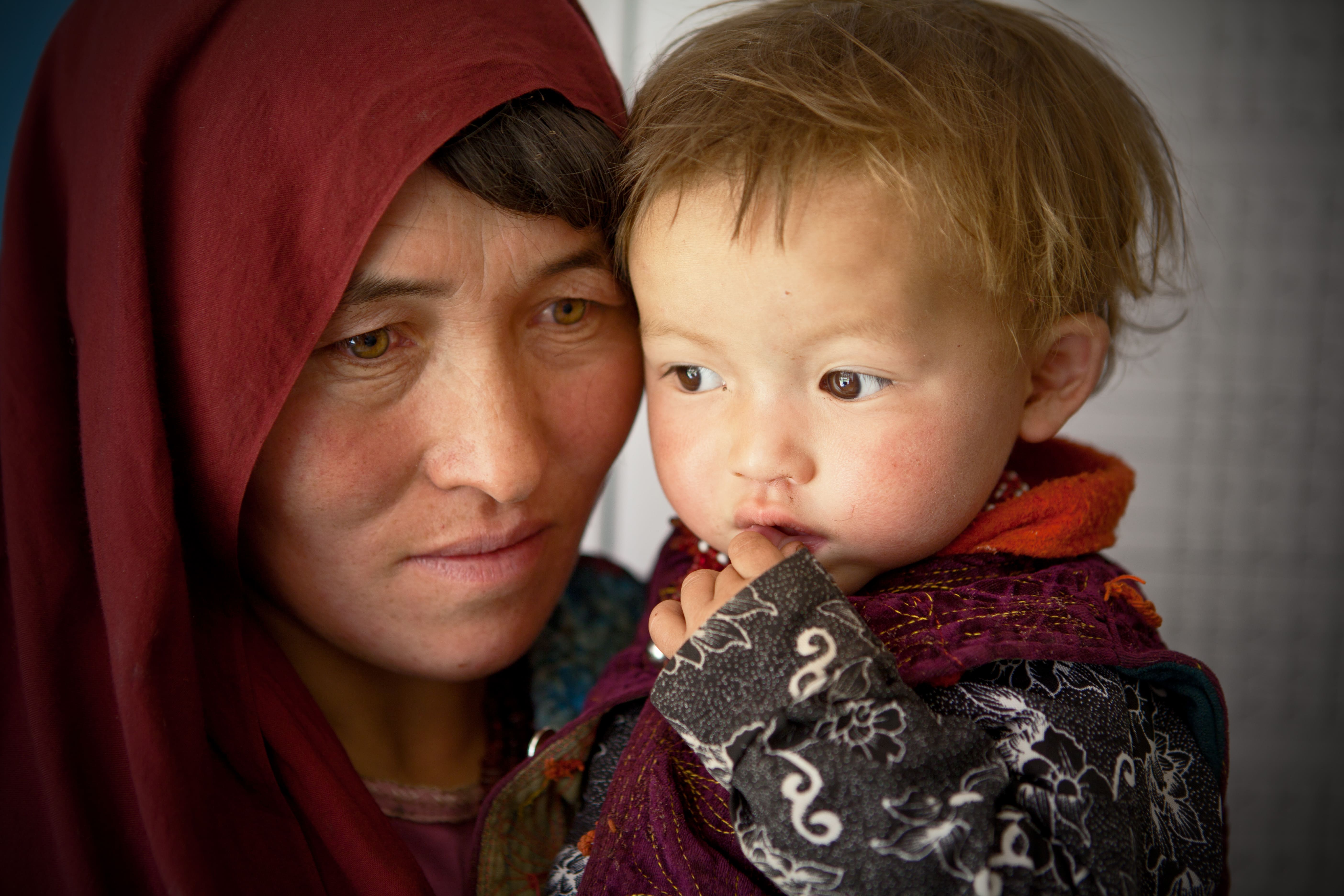 An Afghan woman holds her one year old daughter Roqia at Family Health House on September 8, 2014 in Shiber district of Bamiyan, Afghanistan.
