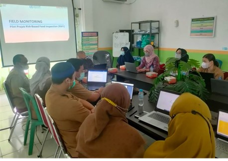 Staff of Ministry of Health, WHO and District Health Office in a meeting room.